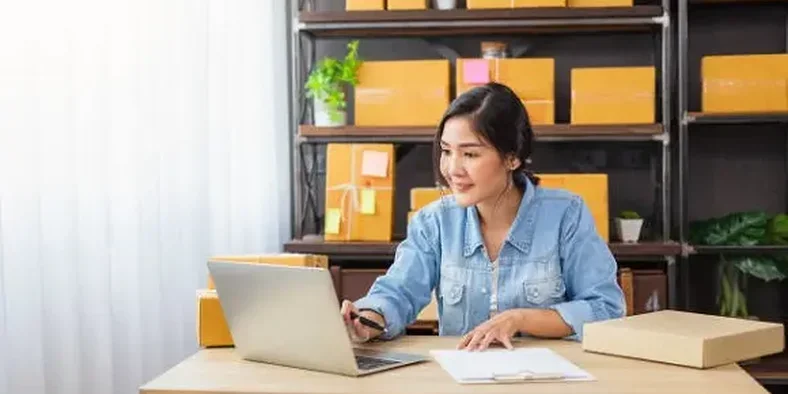 Wanita Asia sedang menggunakan laptop untuk menjalankan bisnis online