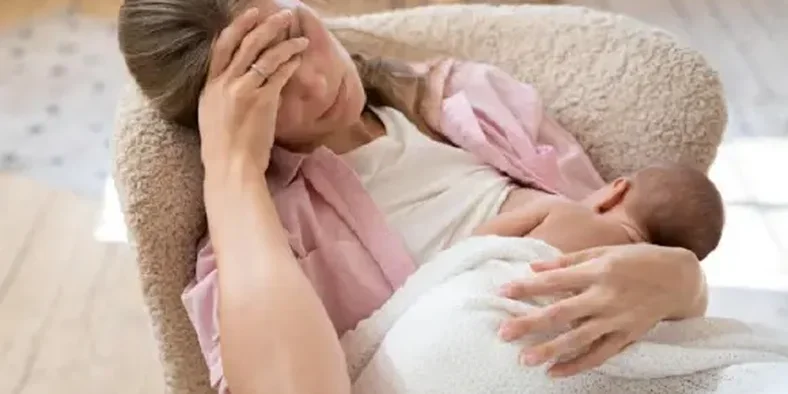 wanita sedang menyusui bayi